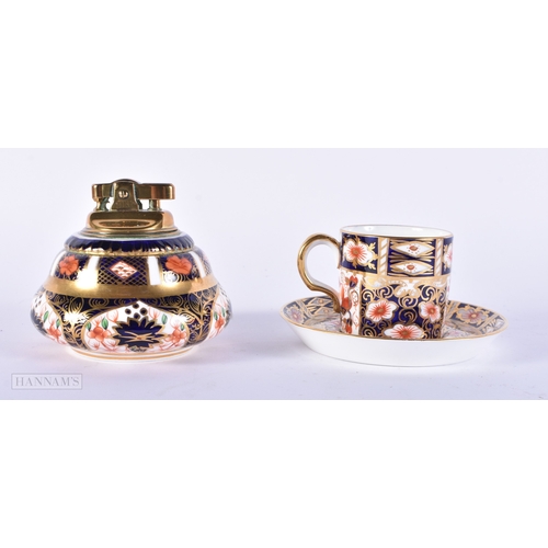 150 - A ROYAL CROWN DERBY IMARI PORCELAIN LIGHTER together with a similar cup and saucer. (3)