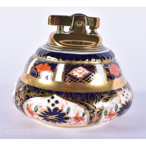 150 - A ROYAL CROWN DERBY IMARI PORCELAIN LIGHTER together with a similar cup and saucer. (3)