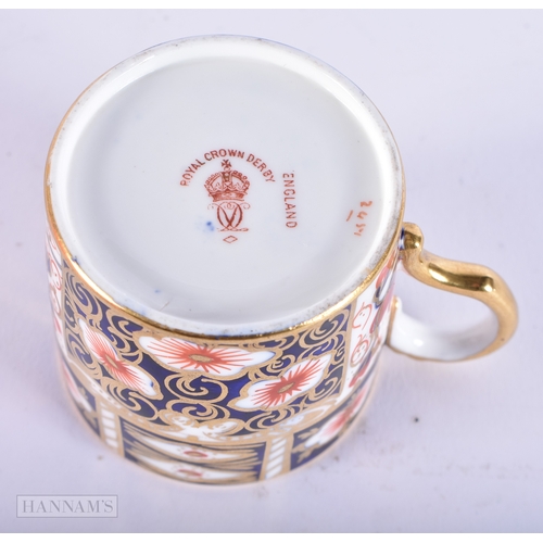 150 - A ROYAL CROWN DERBY IMARI PORCELAIN LIGHTER together with a similar cup and saucer. (3)