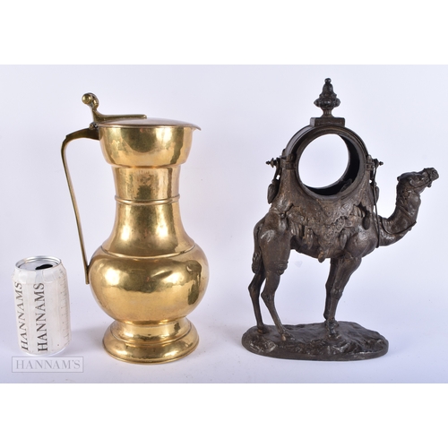 192 - A 19TH CENTURY FRENCH SPELTER CAMEL CLOCK CASE together with a brass flagon. Largest 34 cm high. (2)