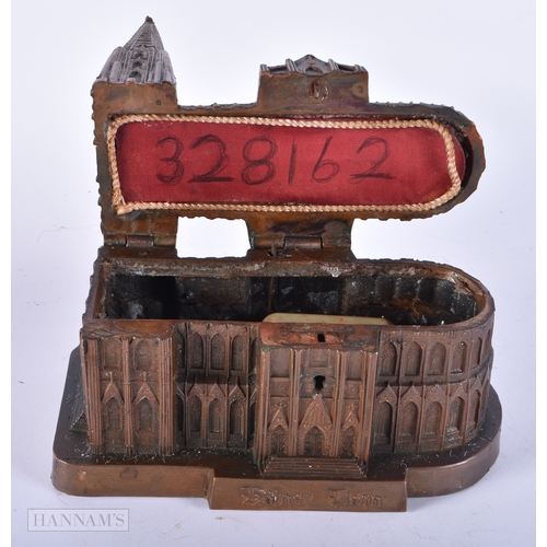 194 - AN ANTIQUE INDIAN BRONZE CASKET together with a musical box cathedral. Largest 12cm wide. (2)