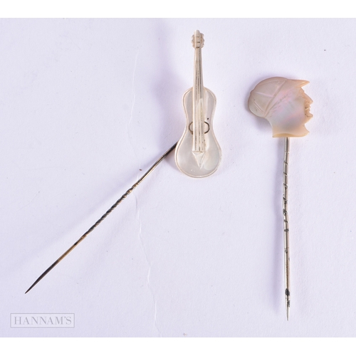 336 - TWO UNUSUAL ANTIQUE MOTHER OF PEARL JOCKEY AND CELLO TIE PINS. 3.5 grams. 8.5 cm x 3.25cm. (2)