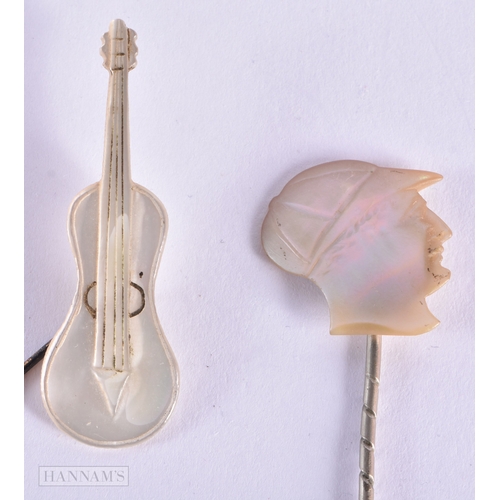 336 - TWO UNUSUAL ANTIQUE MOTHER OF PEARL JOCKEY AND CELLO TIE PINS. 3.5 grams. 8.5 cm x 3.25cm. (2)