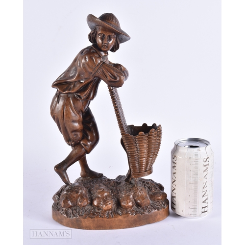 368 - A 19TH CENTURY BAVARIAN CARVED LINDEN WOOD FIGURE OF A MALE modelled leaning upon a basket. 32 cm hi... 