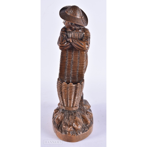 368 - A 19TH CENTURY BAVARIAN CARVED LINDEN WOOD FIGURE OF A MALE modelled leaning upon a basket. 32 cm hi... 