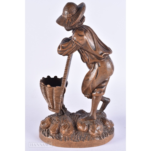 368 - A 19TH CENTURY BAVARIAN CARVED LINDEN WOOD FIGURE OF A MALE modelled leaning upon a basket. 32 cm hi... 