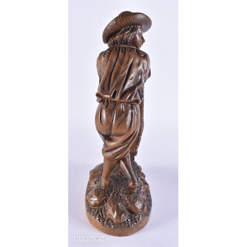 368 - A 19TH CENTURY BAVARIAN CARVED LINDEN WOOD FIGURE OF A MALE modelled leaning upon a basket. 32 cm hi... 