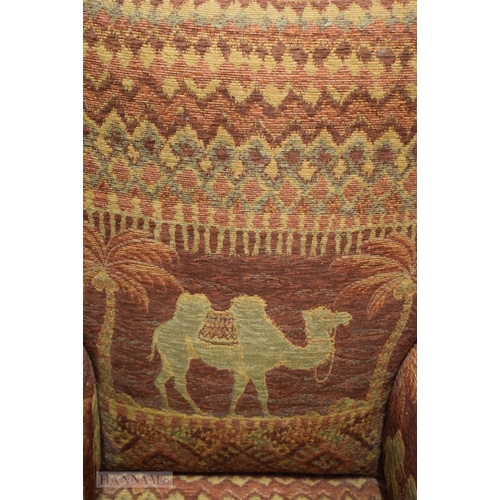 406 - AN UNUSUAL EARLY 20TH CENTURY COUNTRY HOUSE UPHOLSTERED DEEP CHAIR decorated with camels and Eastern... 