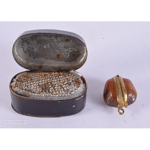 416 - A GEORGE III TOLEWARE NUTMEG GRATER together with an antique nut locket. Largest 5 cm x 2.5 cm. (2)