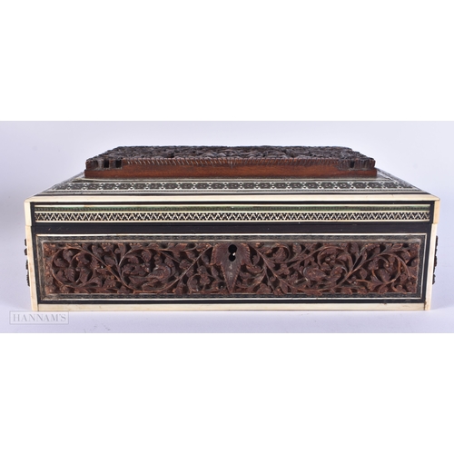 502 - A 19TH CENTURY ANGLO INDIAN CARVED SANDALWOOD CASKET decorated with figures. 24 cm x 14 cm.