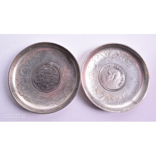 1788 - A PAIR OF CHINESE WHITE METAL COIN DISHES. 221.5 grams. 9.25cm diameter.