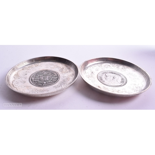 1788 - A PAIR OF CHINESE WHITE METAL COIN DISHES. 221.5 grams. 9.25cm diameter.