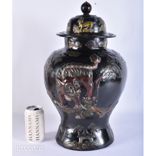 2027 - A VERY RARE 18TH/19TH CENTURY CHINESE BLACK LACQUER VASE AND COVER Qing, decorated in relief with a ... 