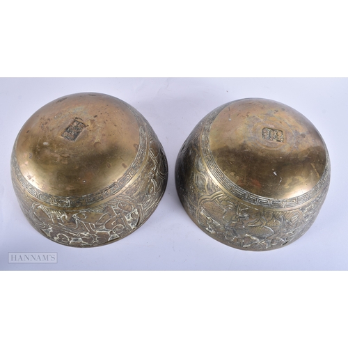 2054 - A LARGE PAIR OF 19TH CENTURY CHINESE BRONZE BOWLS bearing Xuande marks to base. 24 cm diameter.