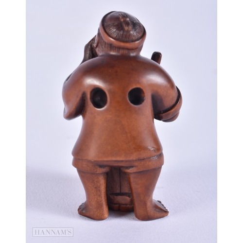 2058 - A JAPANESE CARVED WOOD NETSUKE formed as a male washing clothes. 5 cm x 2.75 cm.