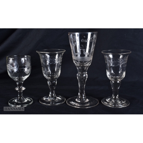 100 - FOUR ANTIQUE GLASSES one engraved with a motto and  birds. Largest 13 cm high. (4)