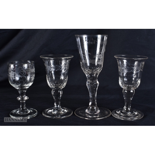 100 - FOUR ANTIQUE GLASSES one engraved with a motto and  birds. Largest 13 cm high. (4)