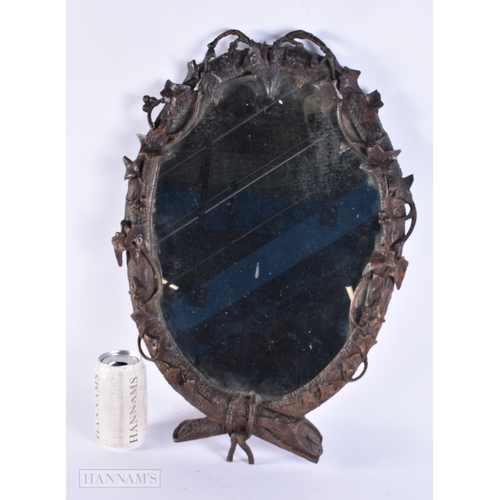 105 - A 19TH CENTURY BAVARIAN BLACK FOREST CARVED WOOD MIRROR of naturalistic form. 52 cm x 34 cm.