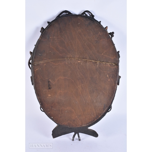 105 - A 19TH CENTURY BAVARIAN BLACK FOREST CARVED WOOD MIRROR of naturalistic form. 52 cm x 34 cm.