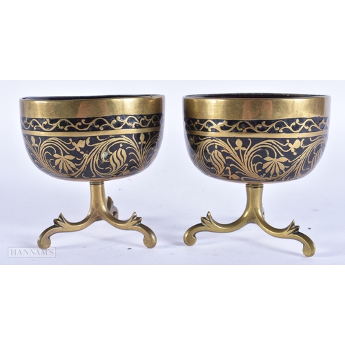 107 - A PAIR OF 19TH CENTURY INDIAN BRONZE MOUNTED COCONUT BOWLS. 8.5 cm x 8.5 cm.