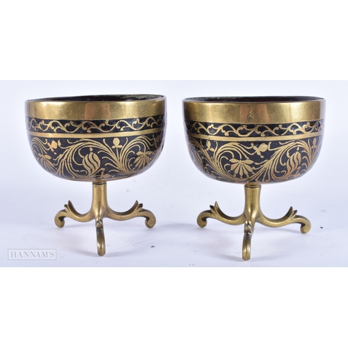 107 - A PAIR OF 19TH CENTURY INDIAN BRONZE MOUNTED COCONUT BOWLS. 8.5 cm x 8.5 cm.