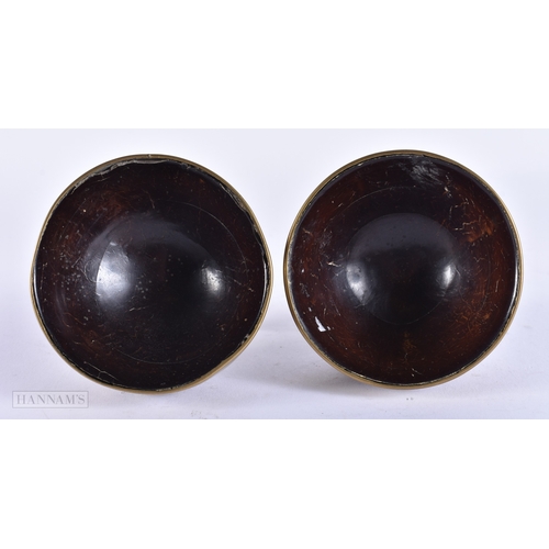 107 - A PAIR OF 19TH CENTURY INDIAN BRONZE MOUNTED COCONUT BOWLS. 8.5 cm x 8.5 cm.