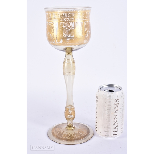 111 - AN UNUSUAL ANTIQUE GILDED GLASS GOBLET decorated with classical chariot scenes. 30 cm high.
