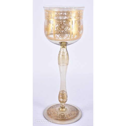 111 - AN UNUSUAL ANTIQUE GILDED GLASS GOBLET decorated with classical chariot scenes. 30 cm high.