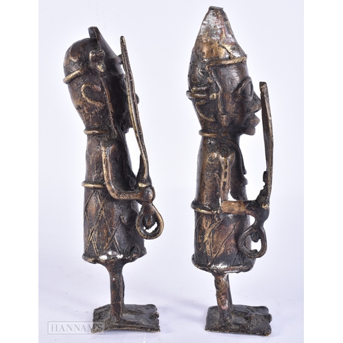 119 - A PAIR OF 19TH CENTURY AFRICAN BENIN BRONZE TRIBAL FIGURES. 21 cm high.