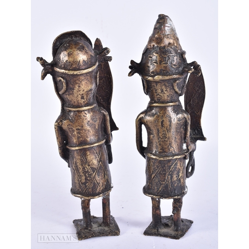 119 - A PAIR OF 19TH CENTURY AFRICAN BENIN BRONZE TRIBAL FIGURES. 21 cm high.