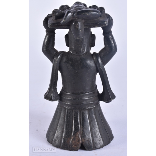 121 - A RARE 18TH/19TH CENTURY INDIAN CARVED STONE DEITY modelled holding aloft a basket inset with a figu... 