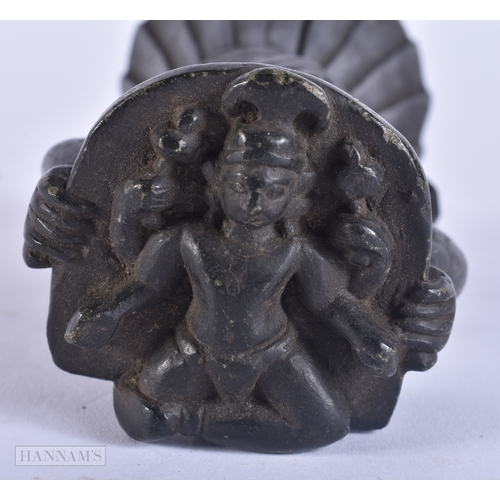 121 - A RARE 18TH/19TH CENTURY INDIAN CARVED STONE DEITY modelled holding aloft a basket inset with a figu... 