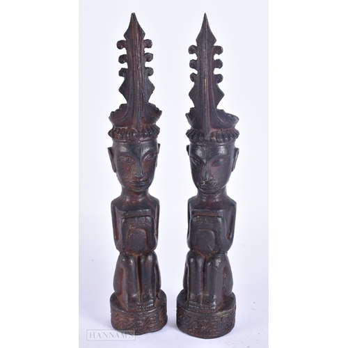 124 - AN UNUSUAL PAIR OF 19TH CENTURY ASIAN EASTERN BRONZE DEITIES modelled with hands clasped. 23 cm high... 