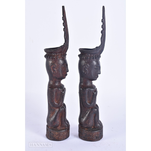 124 - AN UNUSUAL PAIR OF 19TH CENTURY ASIAN EASTERN BRONZE DEITIES modelled with hands clasped. 23 cm high... 