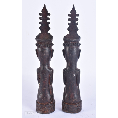 124 - AN UNUSUAL PAIR OF 19TH CENTURY ASIAN EASTERN BRONZE DEITIES modelled with hands clasped. 23 cm high... 