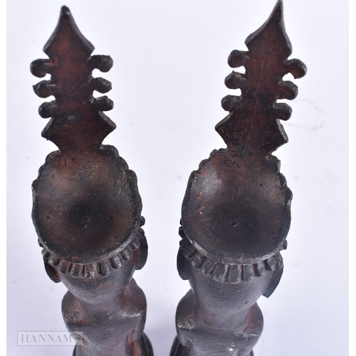 124 - AN UNUSUAL PAIR OF 19TH CENTURY ASIAN EASTERN BRONZE DEITIES modelled with hands clasped. 23 cm high... 