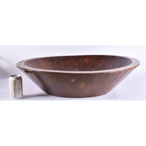 134 - AN EXTREMELY LARGE TREEN CARVED WOOD DAIRY BOWL of monumental proportions. 70 cm diameter.