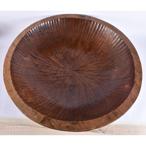 134 - AN EXTREMELY LARGE TREEN CARVED WOOD DAIRY BOWL of monumental proportions. 70 cm diameter.