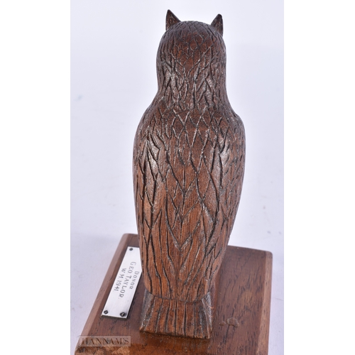142 - AN ART DECO TREEN CARVED WOOD FIGURE OF AN OWL. 15 cm high.