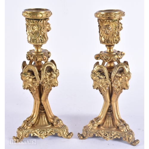 143 - A PAIR OF 19TH CENTURY FRENCH ORMOLU CANDLESTICKS formed with lion and ram mask heads. 20 cm high.