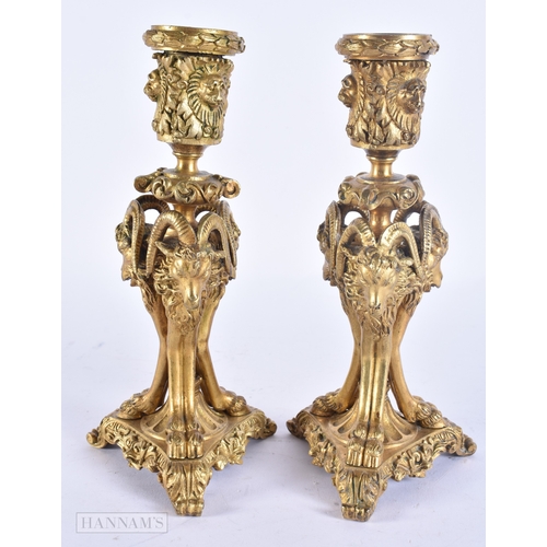 143 - A PAIR OF 19TH CENTURY FRENCH ORMOLU CANDLESTICKS formed with lion and ram mask heads. 20 cm high.