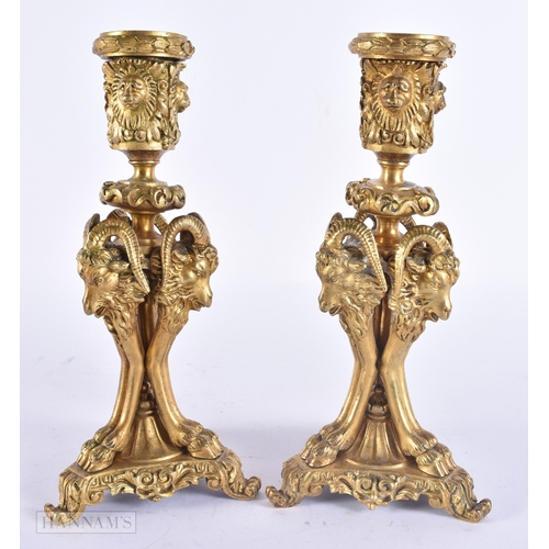 143 - A PAIR OF 19TH CENTURY FRENCH ORMOLU CANDLESTICKS formed with lion and ram mask heads. 20 cm high.