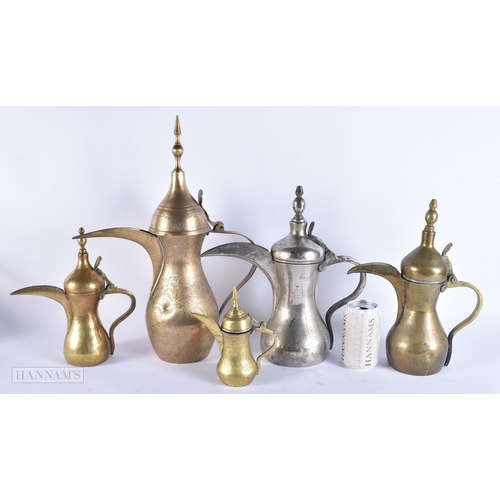 146 - FIVE ISLAMIC MIDDLE EASTERN LONG SPOUT COFFEE POT EWERS. Largest 40 cm high. (5)