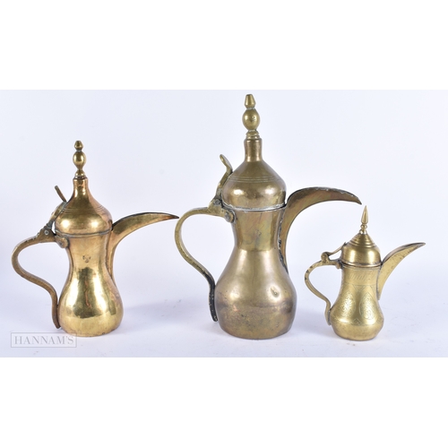 146 - FIVE ISLAMIC MIDDLE EASTERN LONG SPOUT COFFEE POT EWERS. Largest 40 cm high. (5)