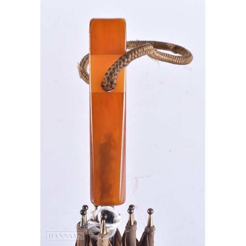 155 - A VINTAGE HONEY HANDLED PARASOL possibly amber (UNTESTED). 64 cm long.