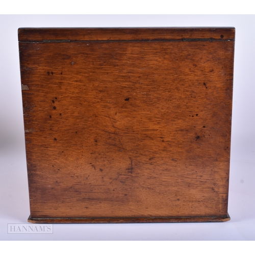 15 - A LARGE VICTORIAN OAK DESK CABINET together with a horn dinner gong. Largest 40 cm x 30 cm. (2)