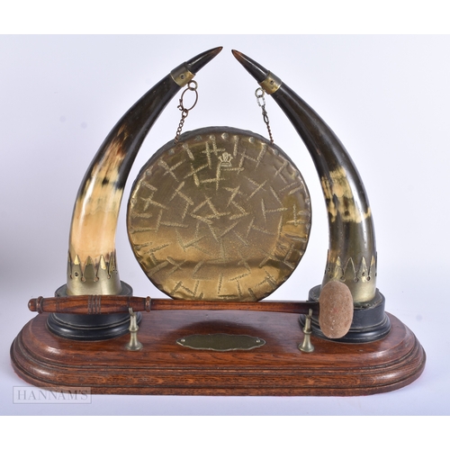 15 - A LARGE VICTORIAN OAK DESK CABINET together with a horn dinner gong. Largest 40 cm x 30 cm. (2)