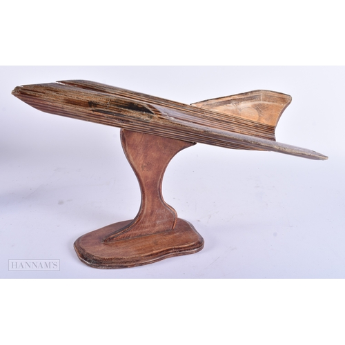 26 - A CARVED PLYWOOD STYLISED MODEL OF A PLANE. 44 cm x 26 cm.