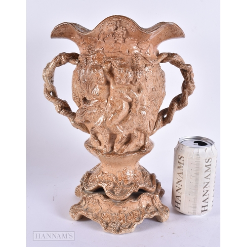 365 - A RARE LARGE EARLY 19TH CENTURY ENGLISH STONEWARE TWIN HANDLED VASE decorated in relief with putti o... 