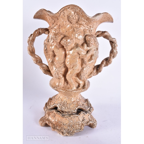 365 - A RARE LARGE EARLY 19TH CENTURY ENGLISH STONEWARE TWIN HANDLED VASE decorated in relief with putti o... 